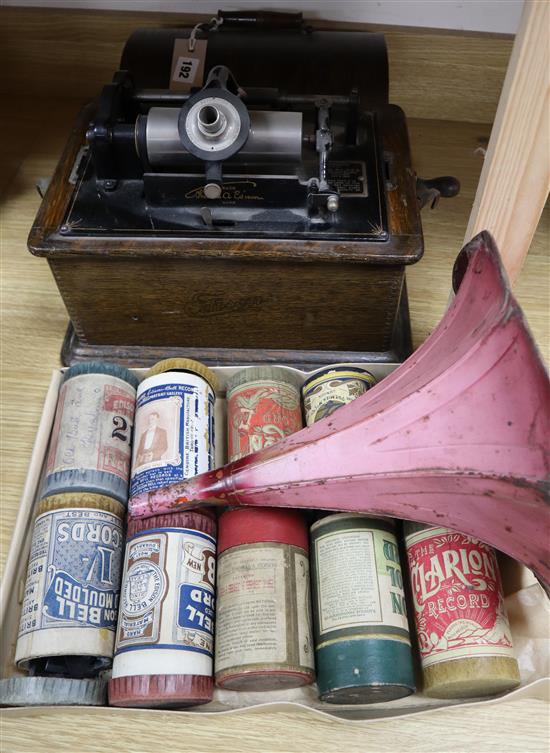 An Edison Standard Phonograph with cylinder in an oak case, pink painted horn and eight wax cylinders